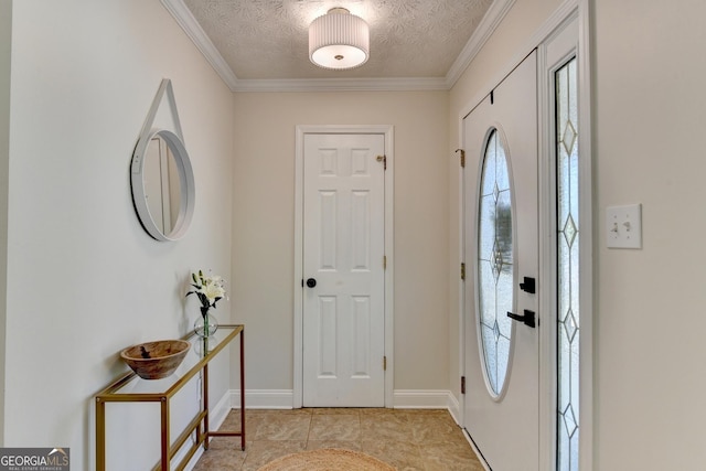 foyer with a textured ceiling, light tile patterned floors, crown molding, and baseboards