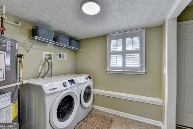 washroom featuring laundry area, visible vents, tile patterned floors, washer and dryer, and water heater