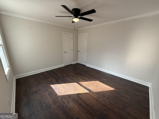 unfurnished room with ornamental molding, dark wood finished floors, a ceiling fan, and baseboards