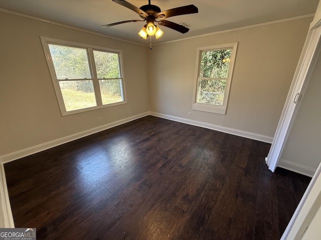 empty room with a ceiling fan, baseboards, ornamental molding, and dark wood-type flooring