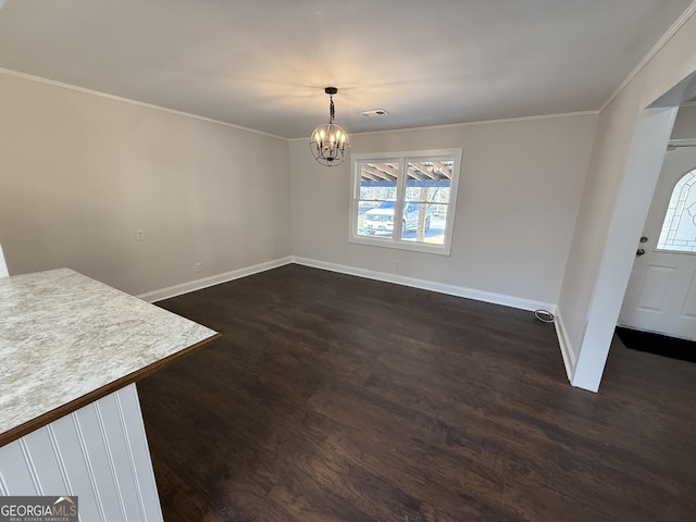 unfurnished dining area with dark wood-style floors, ornamental molding, visible vents, and a notable chandelier