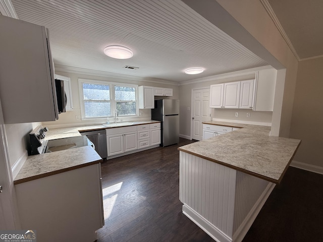 kitchen featuring visible vents, white cabinets, a peninsula, stainless steel appliances, and a sink