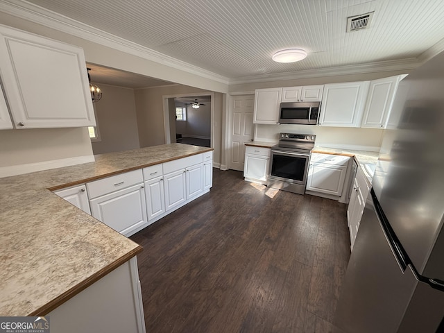 kitchen featuring visible vents, white cabinetry, light countertops, appliances with stainless steel finishes, and crown molding