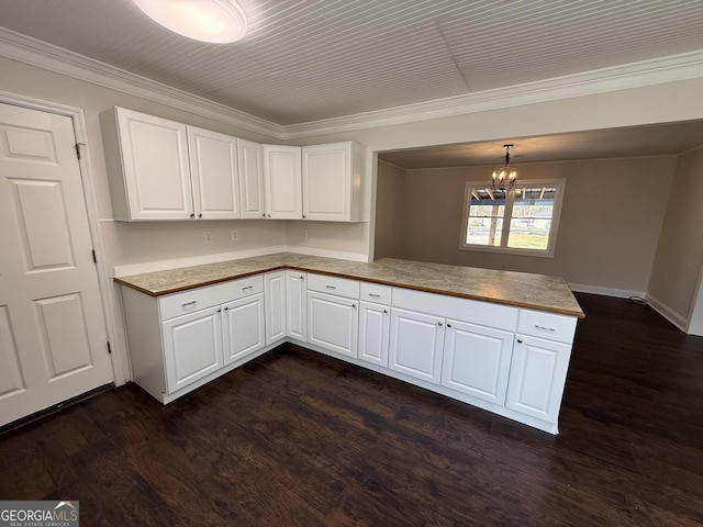 kitchen with pendant lighting, dark wood-style flooring, light countertops, white cabinets, and a peninsula