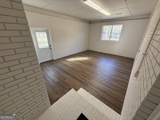 foyer entrance featuring visible vents and dark wood finished floors