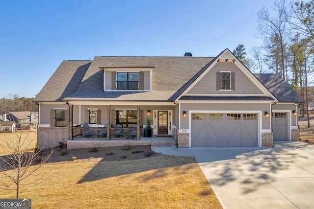 craftsman-style home featuring driveway, roof with shingles, covered porch, a standing seam roof, and brick siding