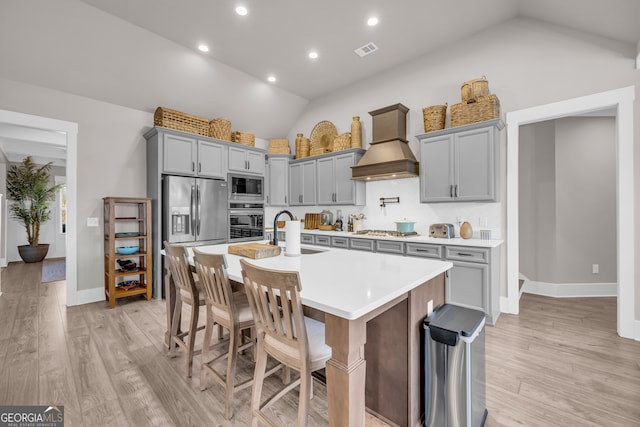 kitchen with a sink, visible vents, light countertops, appliances with stainless steel finishes, and custom exhaust hood