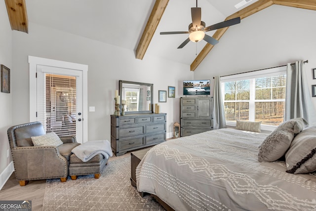 bedroom featuring light wood finished floors, multiple windows, high vaulted ceiling, and beam ceiling