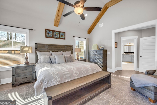 bedroom featuring high vaulted ceiling, beam ceiling, visible vents, and wood finished floors