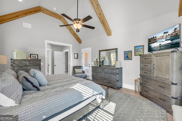 bedroom featuring beam ceiling, visible vents, light wood-style floors, ceiling fan, and high vaulted ceiling