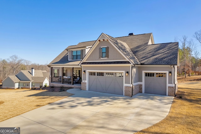 craftsman inspired home with metal roof, a porch, brick siding, concrete driveway, and a standing seam roof