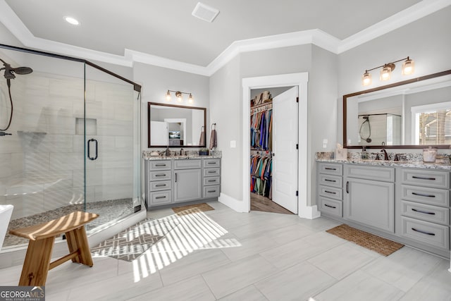 bathroom with visible vents, vanity, baseboards, ornamental molding, and a shower stall