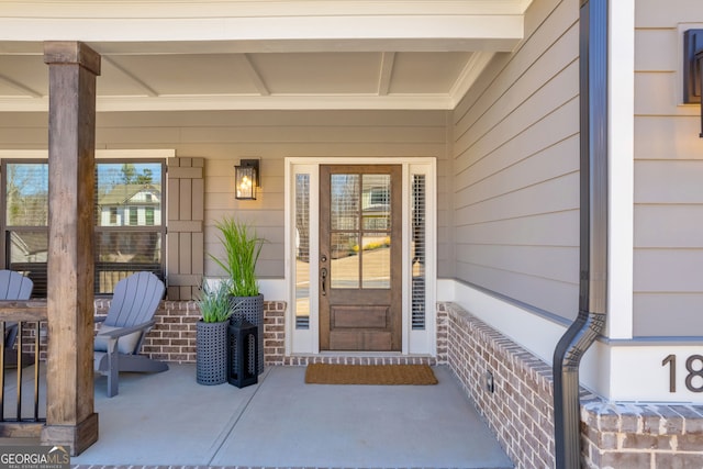 view of exterior entry featuring a porch