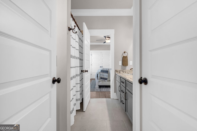 full bath featuring tile patterned flooring, a ceiling fan, and vanity