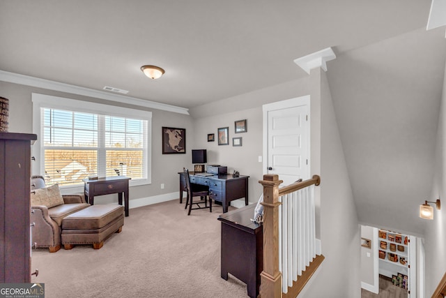 office space with light colored carpet, visible vents, crown molding, and baseboards