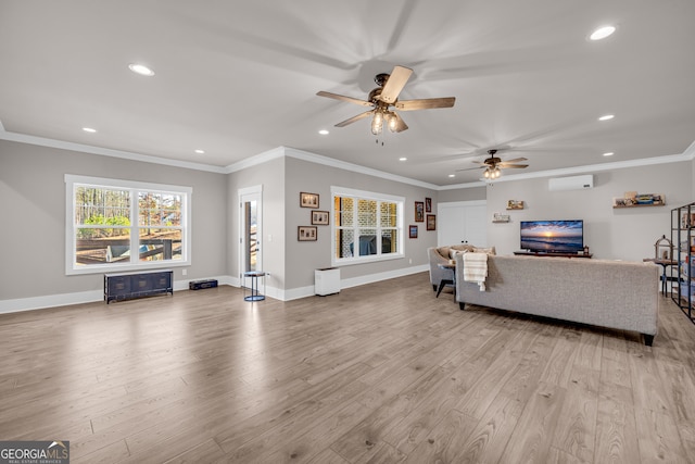 living room featuring light wood-type flooring, baseboards, and crown molding