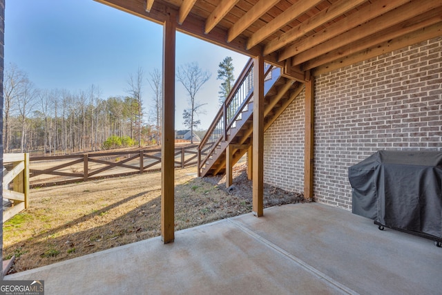 view of patio featuring a grill, stairs, and a fenced backyard