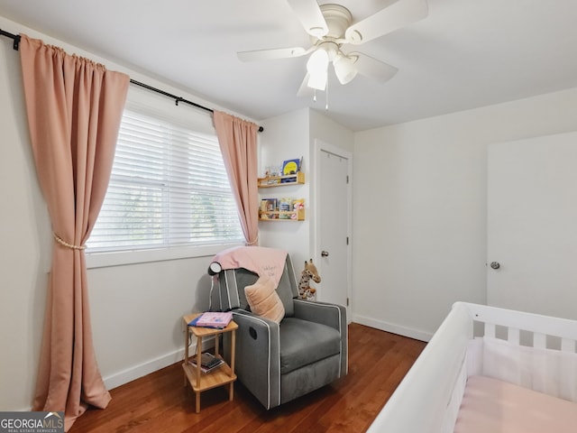 bedroom featuring dark wood-style floors, ceiling fan, and baseboards