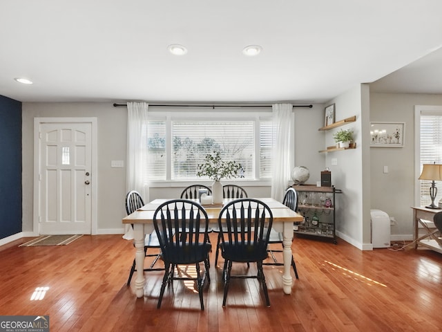 dining space featuring a healthy amount of sunlight, baseboards, and wood finished floors