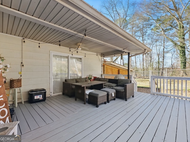 wooden terrace featuring a fenced backyard and outdoor lounge area