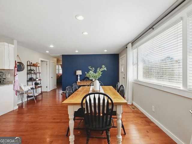 dining room with recessed lighting, visible vents, baseboards, and wood finished floors