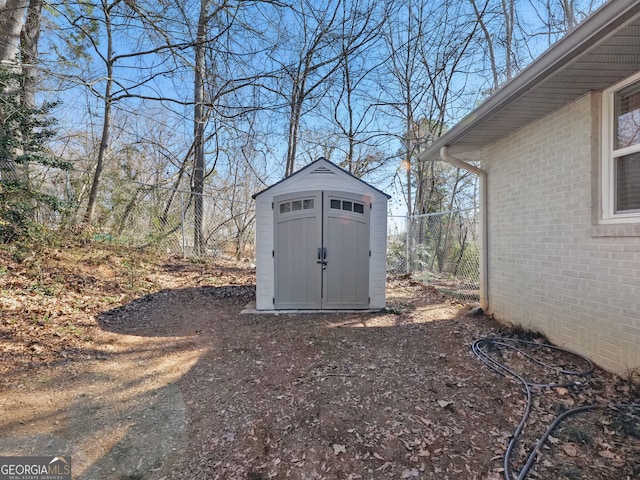 view of shed with fence