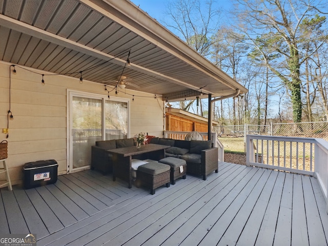 wooden terrace with a fenced backyard and an outdoor hangout area