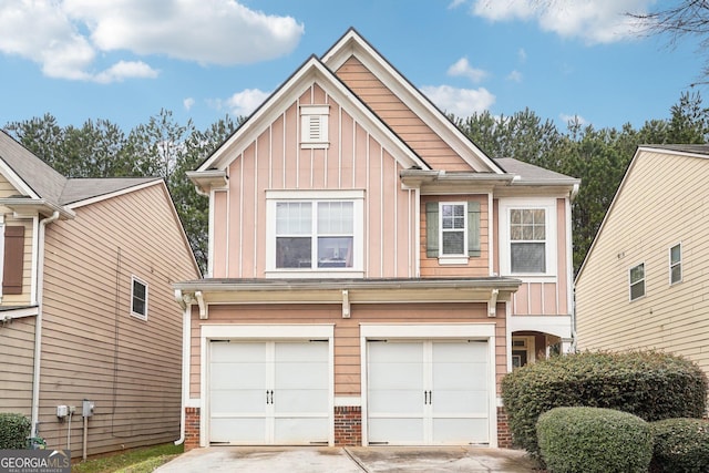 view of front facade featuring driveway, an attached garage, board and batten siding, and brick siding