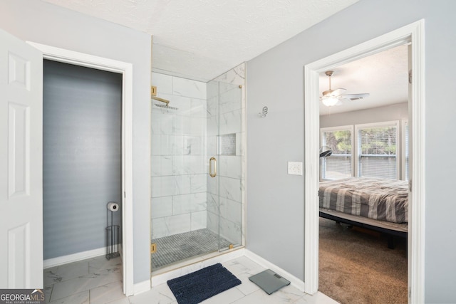 ensuite bathroom featuring marble finish floor, baseboards, a stall shower, and ensuite bathroom