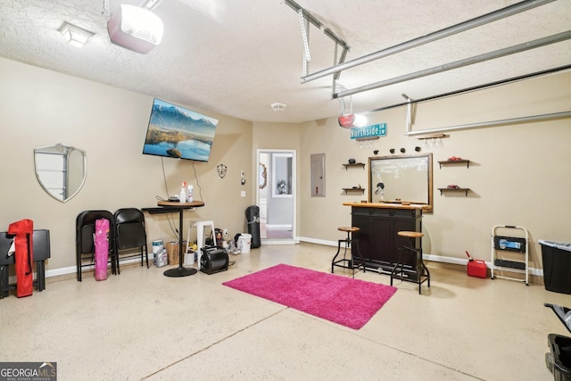 garage with electric panel and baseboards