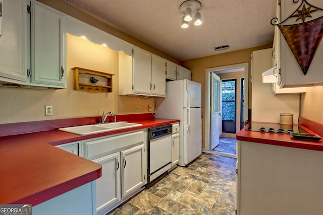 kitchen with white appliances, white cabinets, a sink, and under cabinet range hood