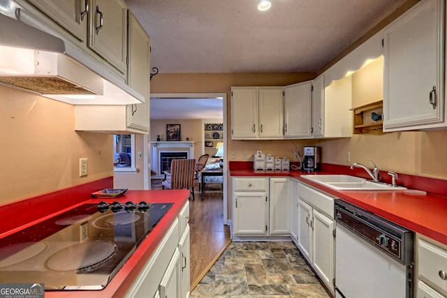 kitchen featuring white dishwasher, under cabinet range hood, electric cooktop, a sink, and white cabinets