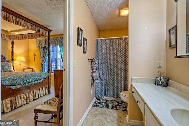 bathroom featuring a textured ceiling, toilet, vanity, baseboards, and a shower with curtain