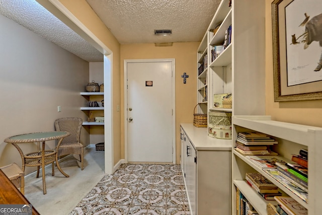 interior space featuring visible vents and a textured ceiling