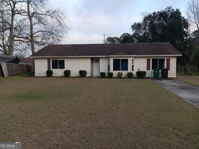 single story home with fence and a front lawn