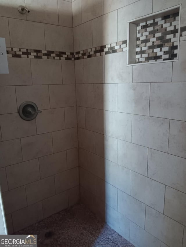 bathroom with a tile shower