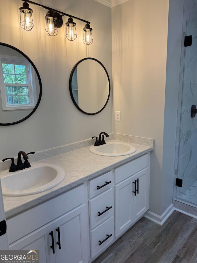 full bathroom featuring double vanity, wood finished floors, a stall shower, and a sink