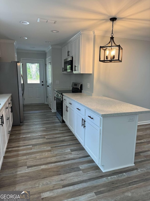 kitchen with white cabinets, light countertops, ornamental molding, appliances with stainless steel finishes, and hanging light fixtures