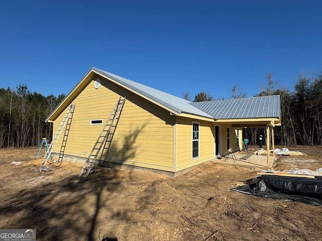 view of side of property with metal roof