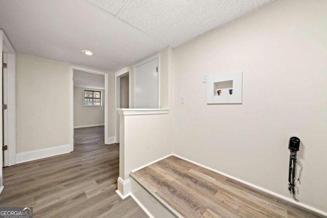 laundry room with hookup for a washing machine, laundry area, baseboards, and wood finished floors