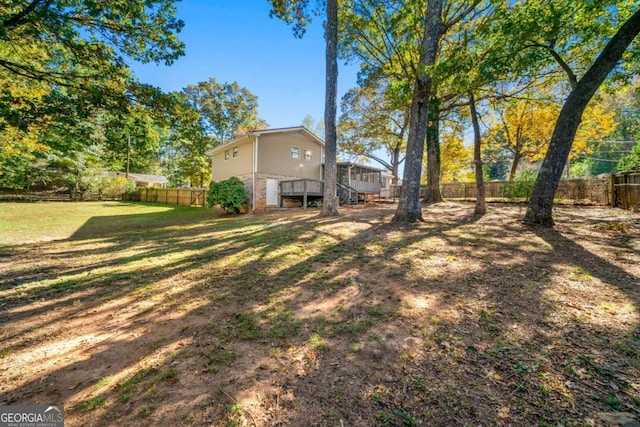 view of yard with stairs and a fenced backyard