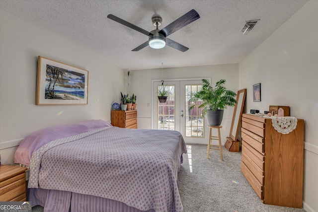 bedroom featuring a textured ceiling, light carpet, visible vents, access to outside, and french doors