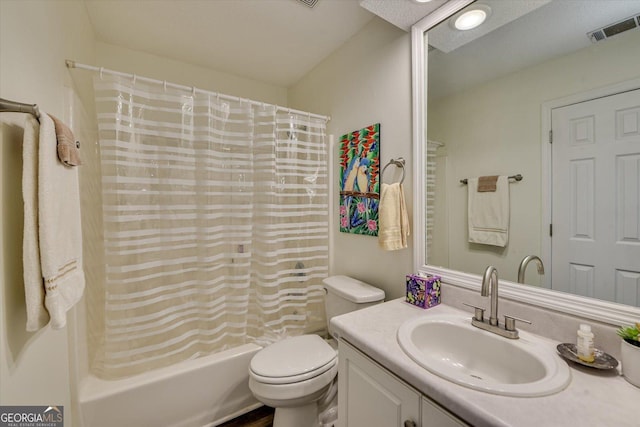 bathroom with visible vents, shower / tub combo with curtain, vanity, and toilet