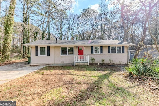 ranch-style home with crawl space, driveway, a front lawn, and brick siding