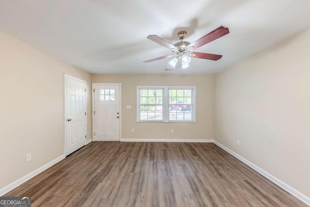 interior space with ceiling fan, baseboards, and wood finished floors