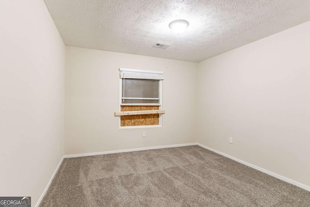 empty room featuring baseboards, visible vents, a textured ceiling, and carpet flooring