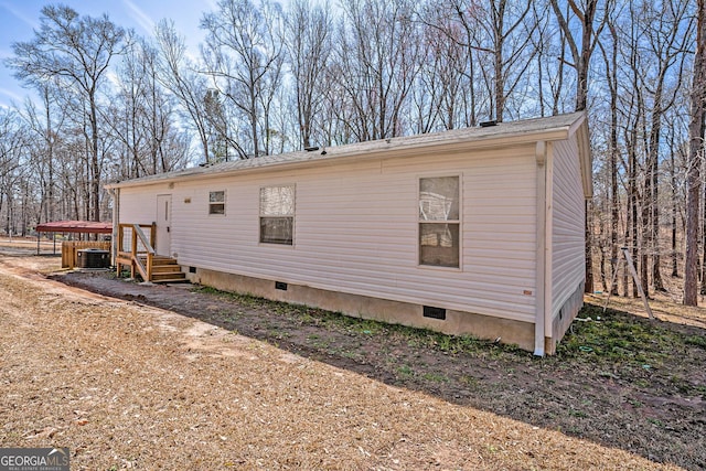 exterior space with crawl space and central air condition unit