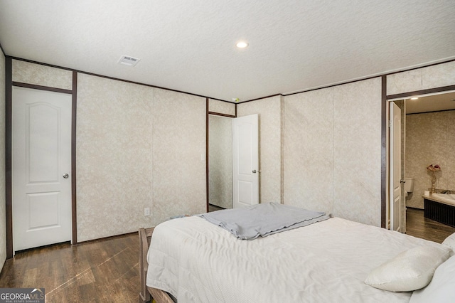 bedroom with visible vents and dark wood-type flooring