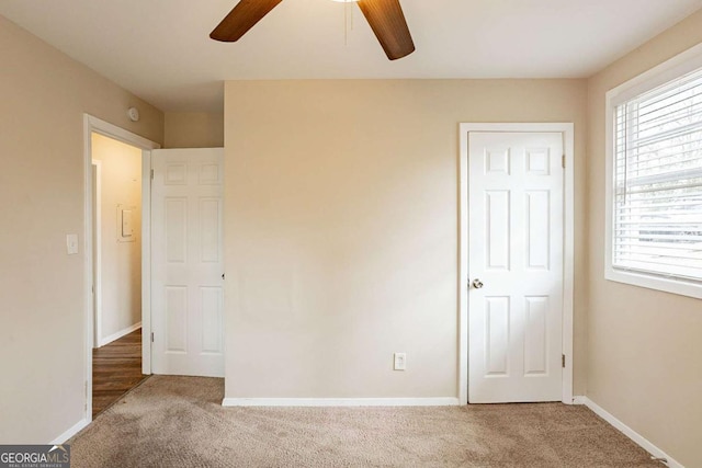 unfurnished bedroom featuring carpet floors, ceiling fan, and baseboards