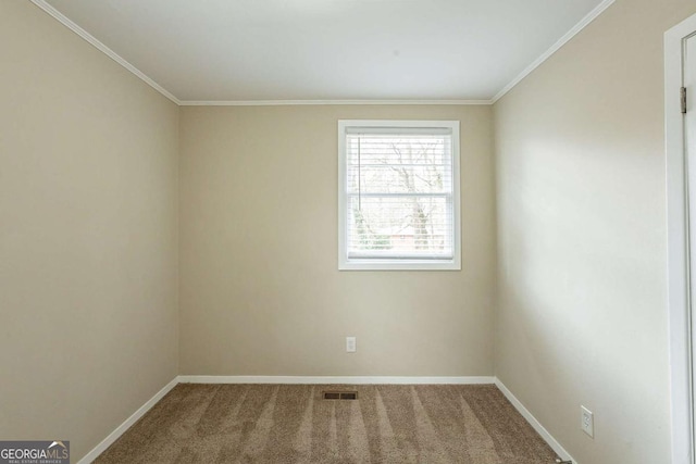 carpeted spare room with baseboards, visible vents, and crown molding